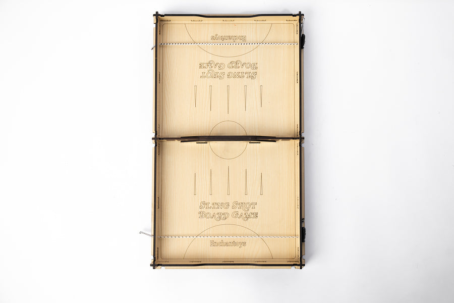 A labeled Sling Shot Board Game with a wooden surface and a set of instructions printed on it.