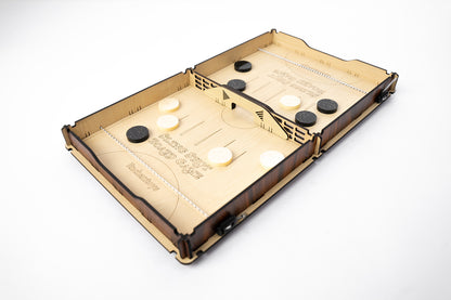 Enchantoys’ handcrafted Slingshot game board with engraved text and neatly arranged playing pucks. The board is divided into two halves with a central goal slit for fast-paced action.